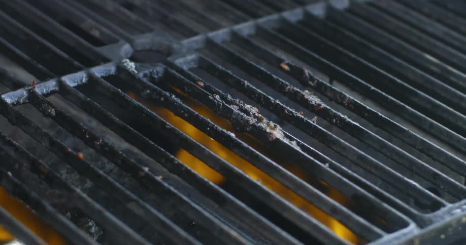 Water is thrown onto a grill grate