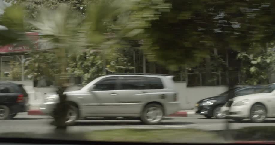 The car is traveling through the neighborhood