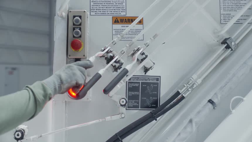 Levers are pushed on the outside of a truck