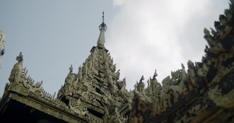 Decorative buildings stand tall under a cloudy blue sky
