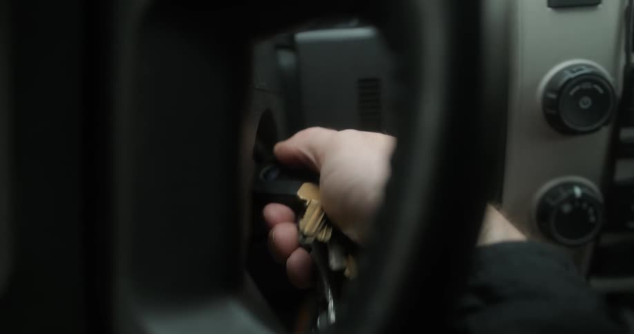 A man turns keys in a car ignition