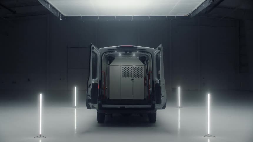 Lights glow around a van in a warehouse