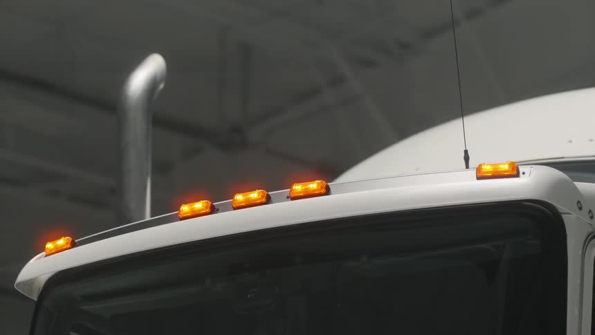 Reflectors on the roof of a semi's cab glow