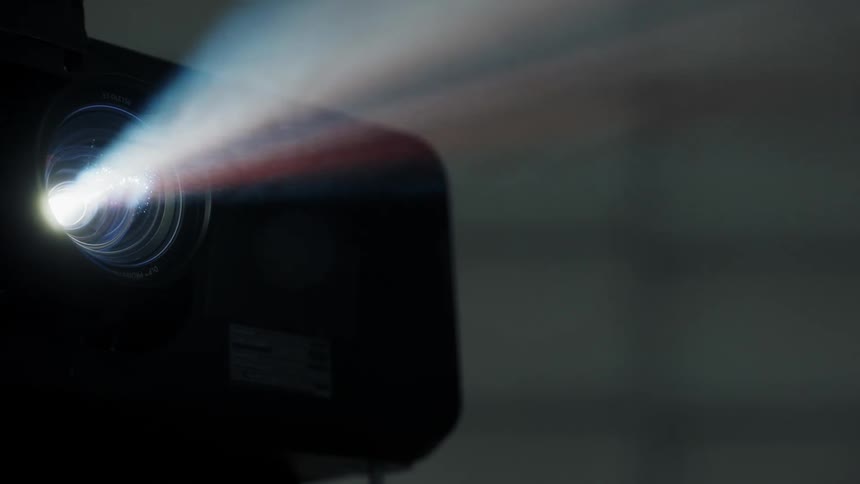 A beam of light shines from a projector
