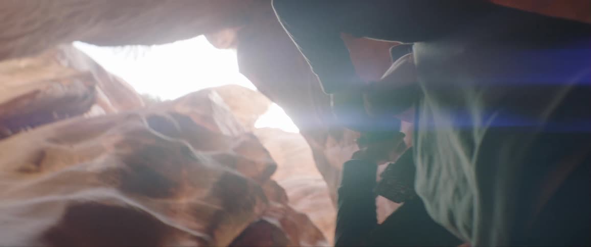 A woman photographs the inside of a cavern