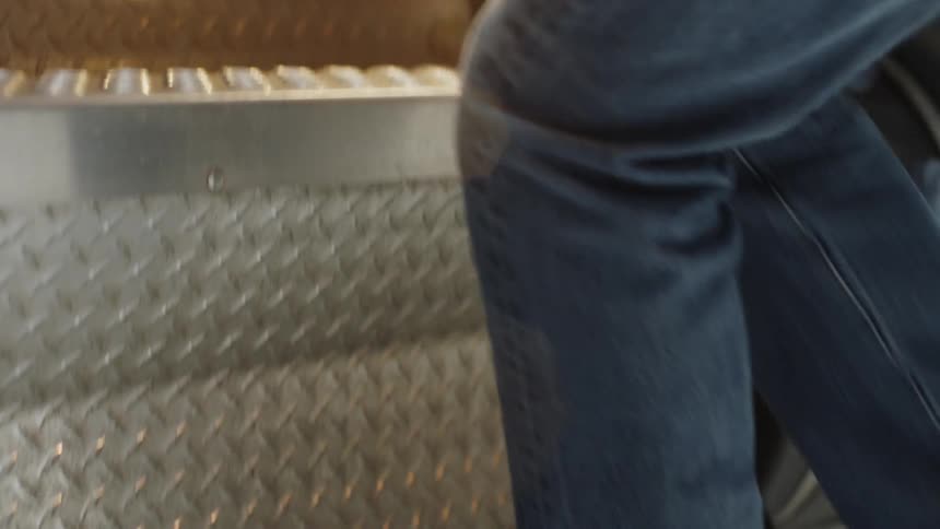 A trucker climbs into a truck