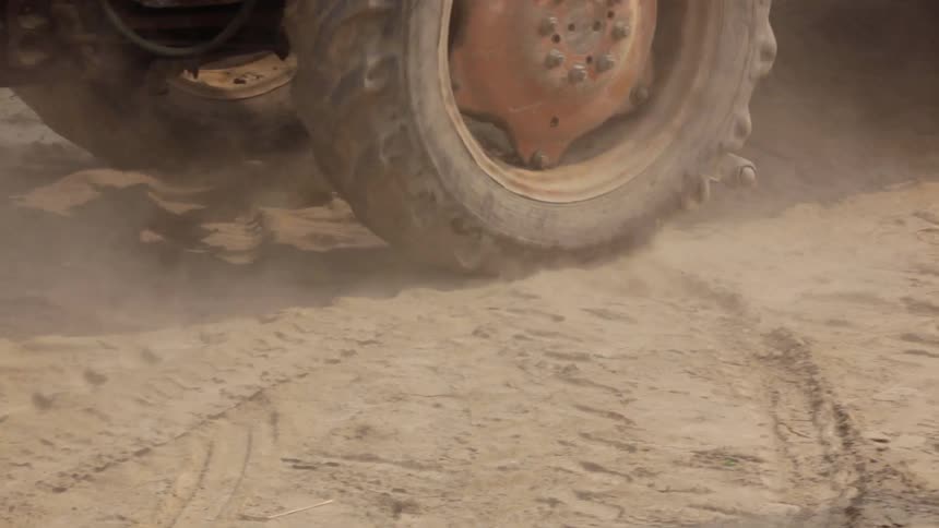 The tractor slowly moves in the dirt