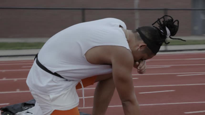 Man working out at a track in the afternoon