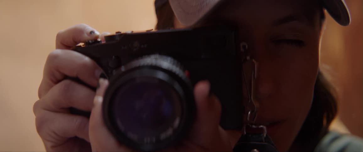 A woman uses a camera outdoors