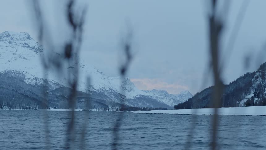 View of mountains across the water in winter