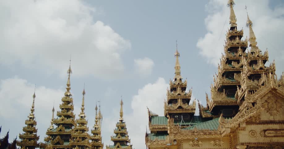 Decorative buildings stand tall under a cloudy blue sky