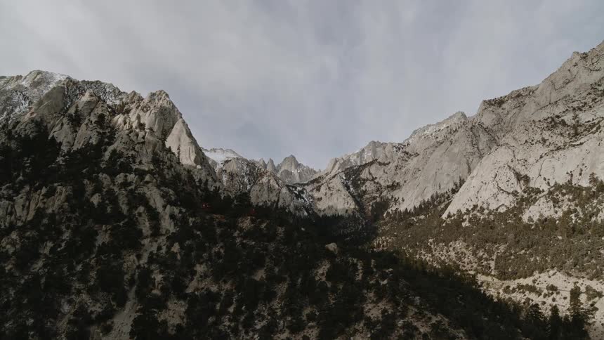 Snow covered mountains under a cloudy sky