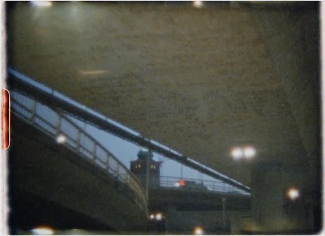 Cars drive on a city highway at night