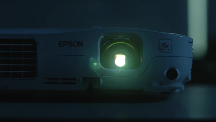 Projection light shines in a dim room