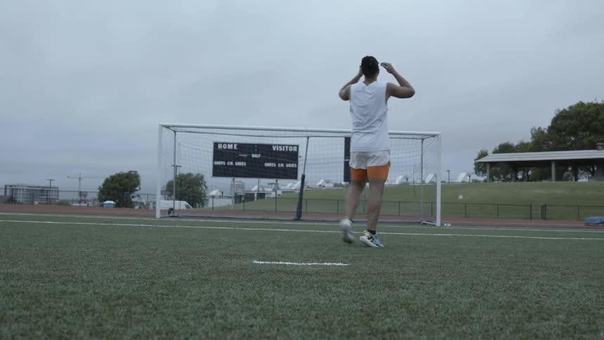 A soccer player misses the net