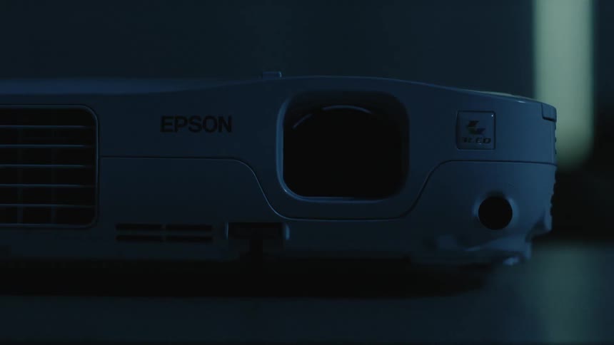 A projector sits on top of a table
