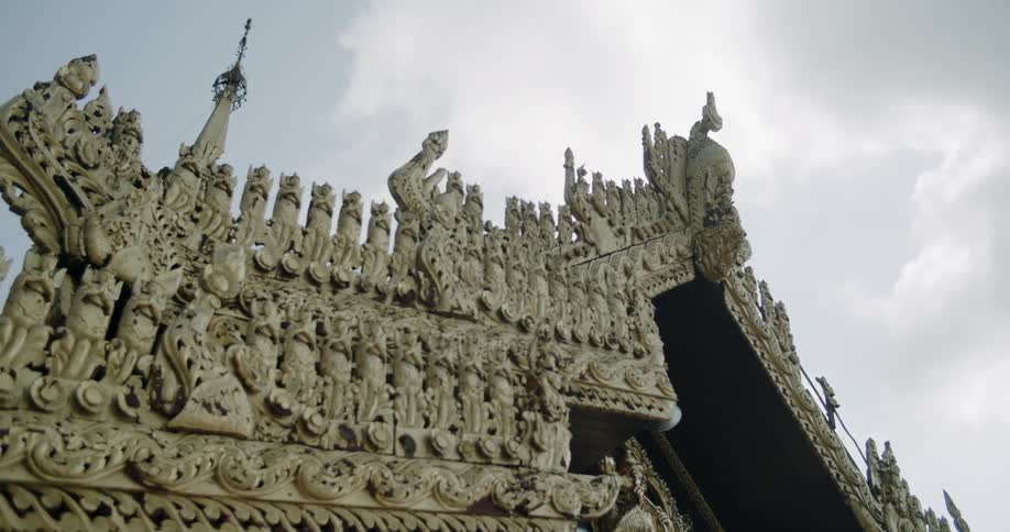 Building with ornate architecture on it outside on a cloudy day
