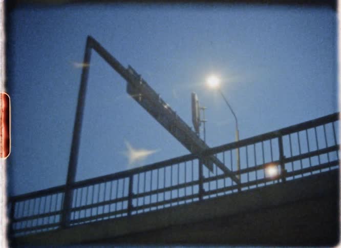 A street lamp shines above a city street