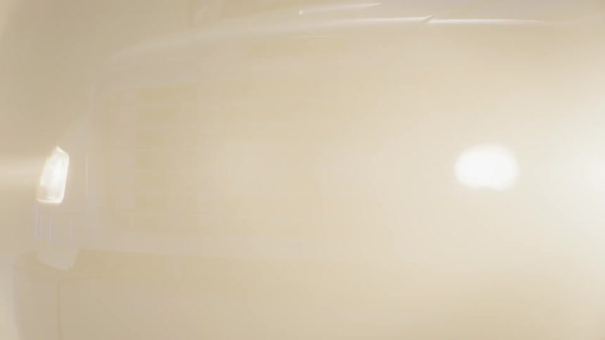 The headlights and grill of a parked truck at night