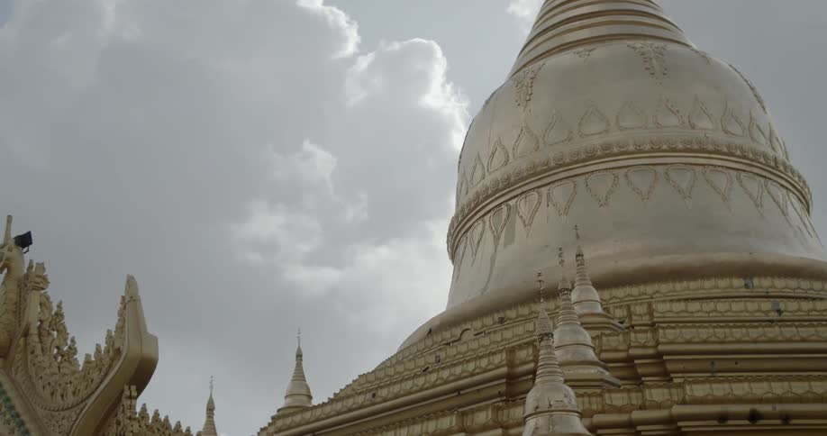 A buildings dome and roof are ornately carved