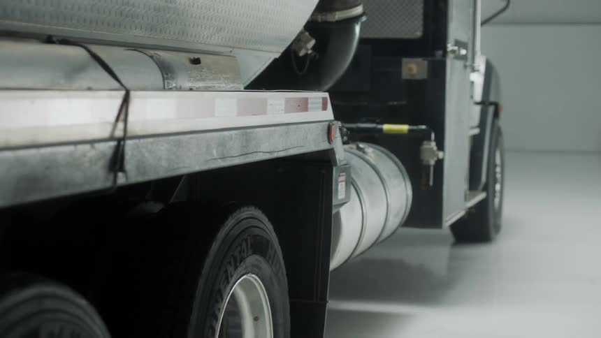 A semi is parked in a warehouse