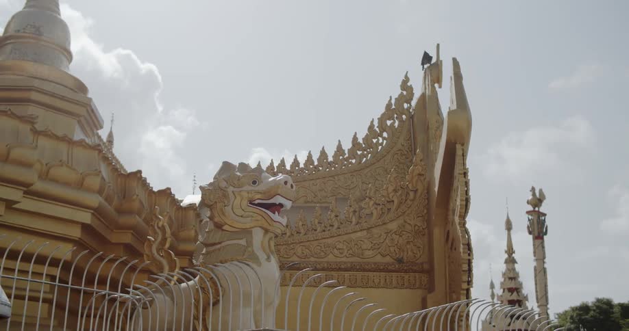Lion and dragon statues surround a temple building