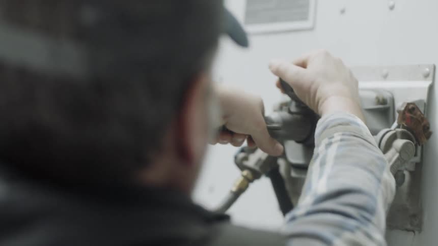 A man plugs a plug into a port