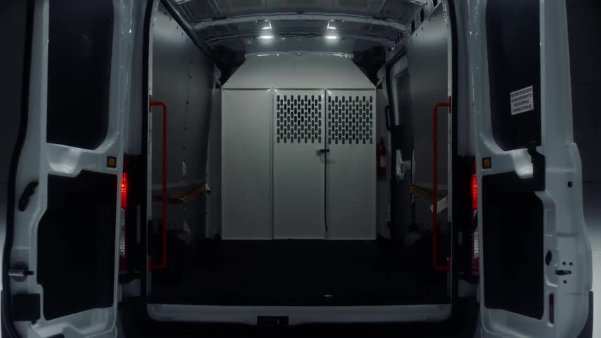A utility van is parked with its doors open