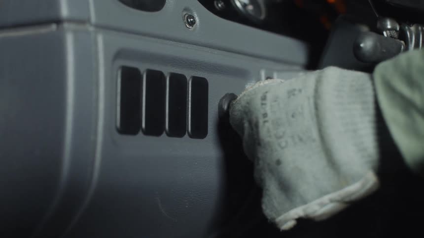 A trucker turns a key in an ignition