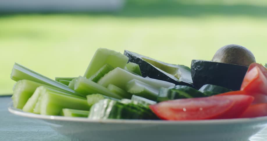 Shadows move over a plate of vegetables