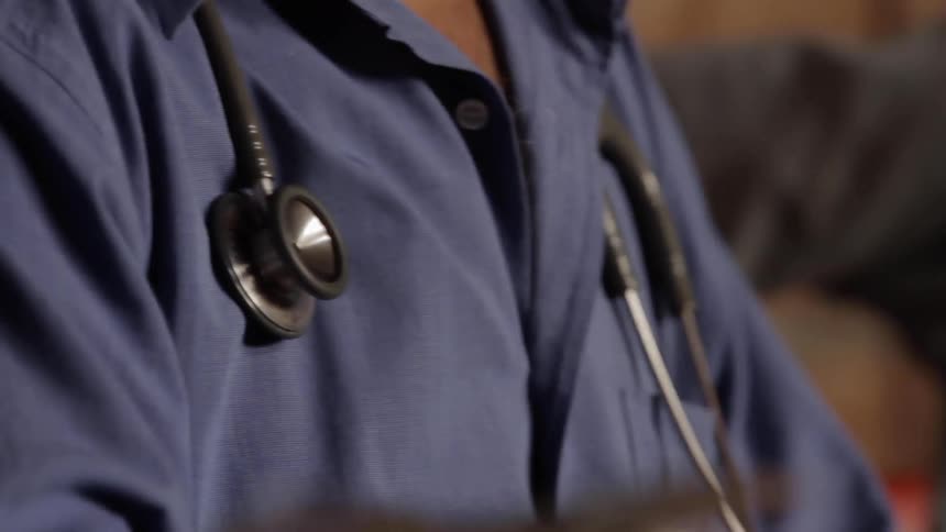A doctor is wearing a stethoscope