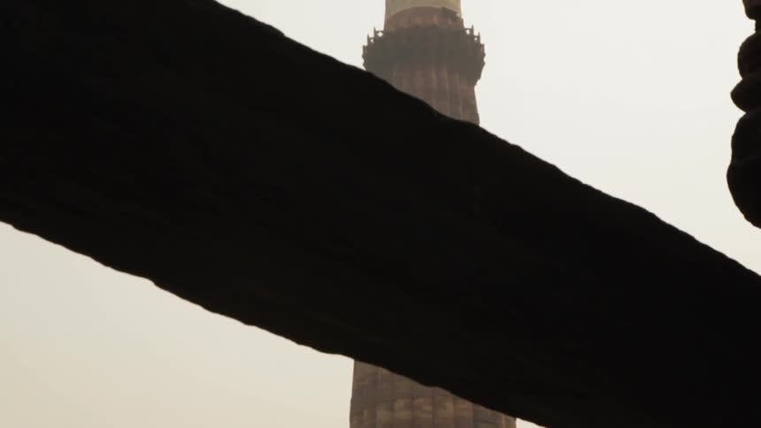 Tall tower stands under the cloudy sky