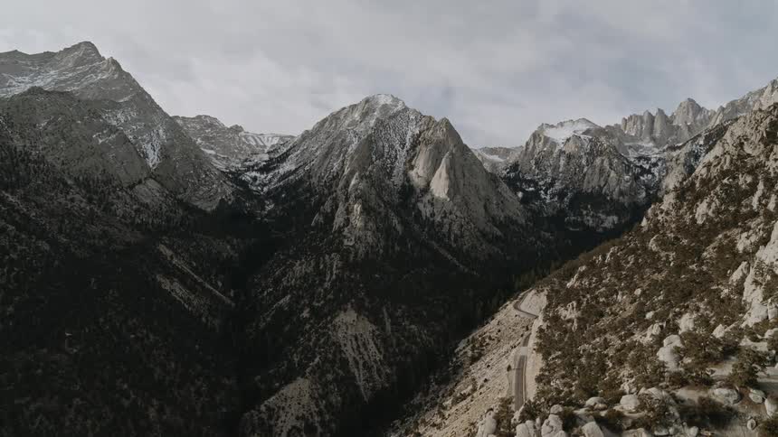 Clouds over tree covered mountains