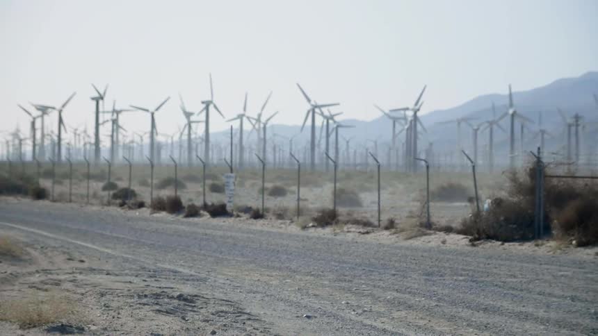Windmills spin in a large open field