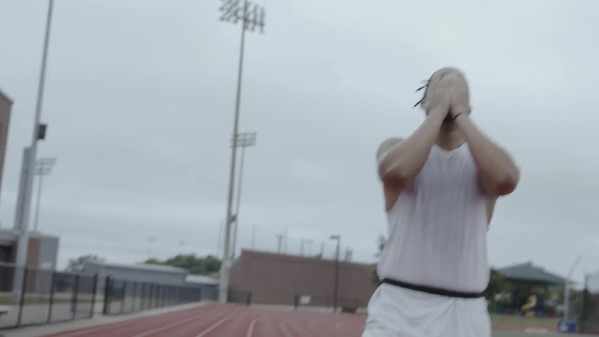 An athlete catches his breath as he walks