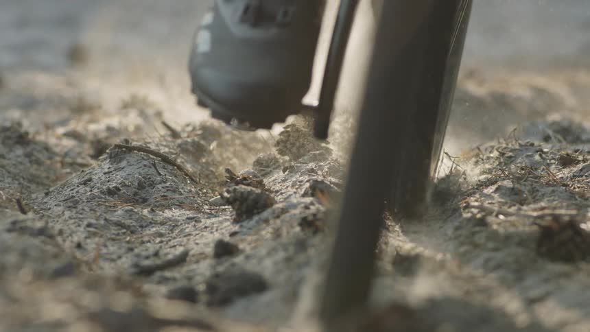 A bike drives over the dirt
