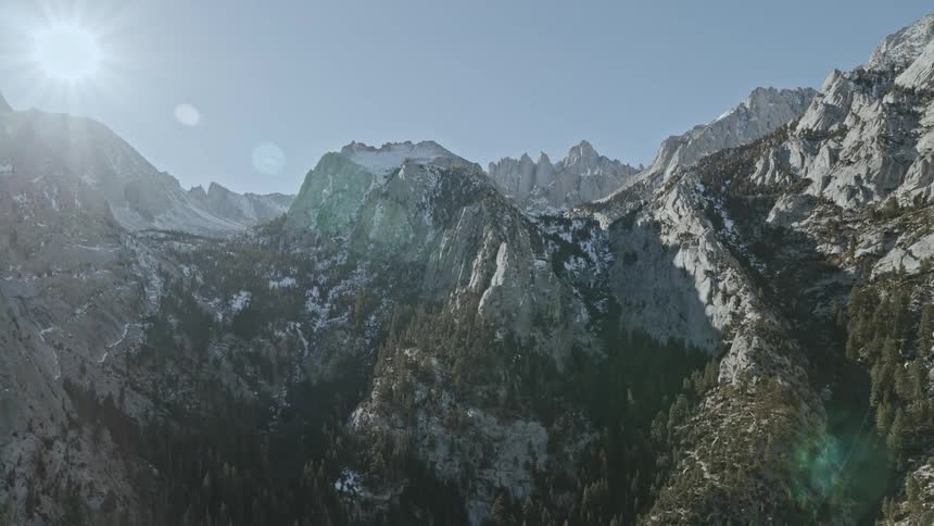 Sun shines over snowy mountains