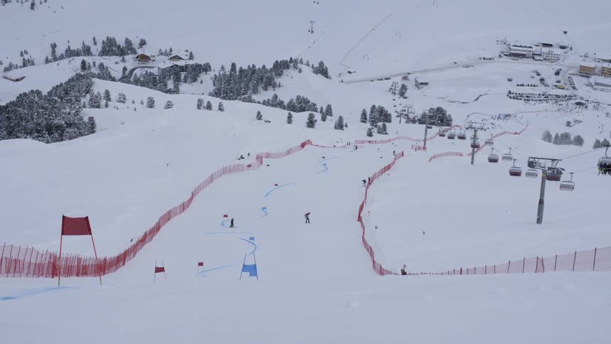 Skiers glide down a snowy mountainside