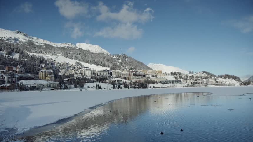 Water flows in the lake by the mountains