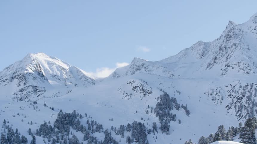 Snow covered mountain wilderness on clear day