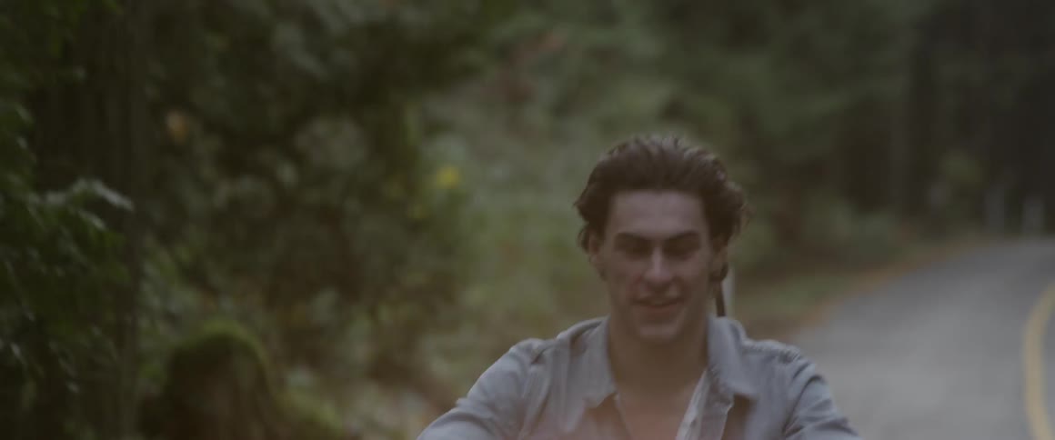 A man laughs as he rides on the motorcycle