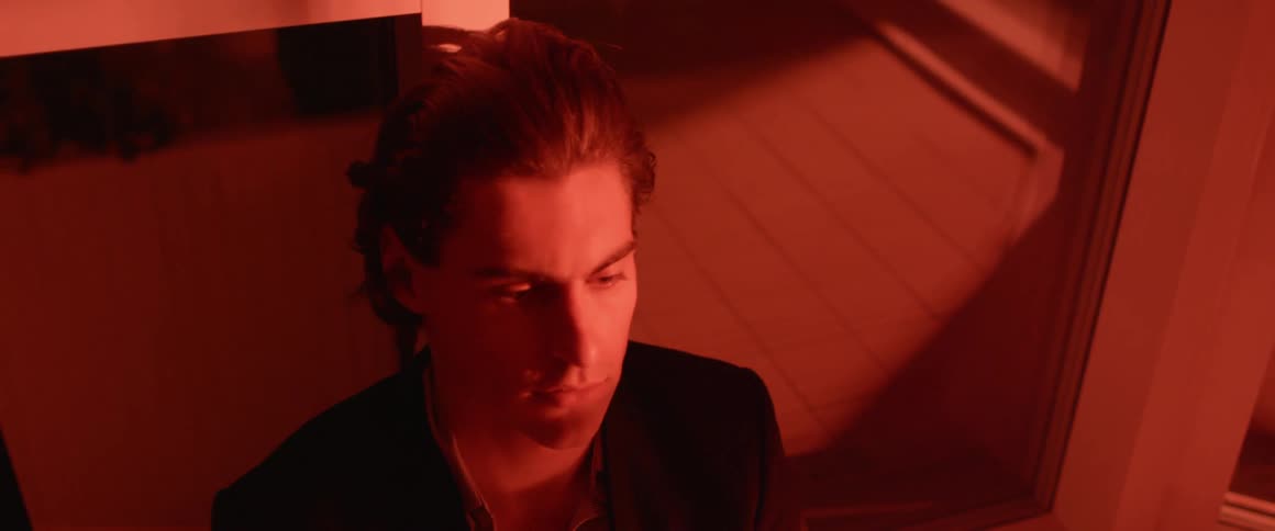 Man blinks his eyes as he stares intently