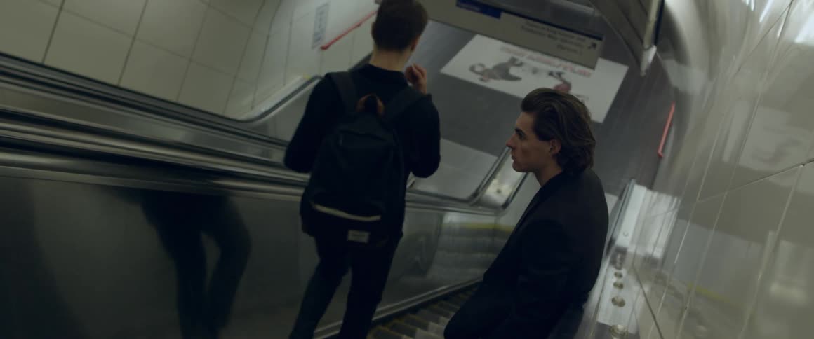 A man walks down an escalator