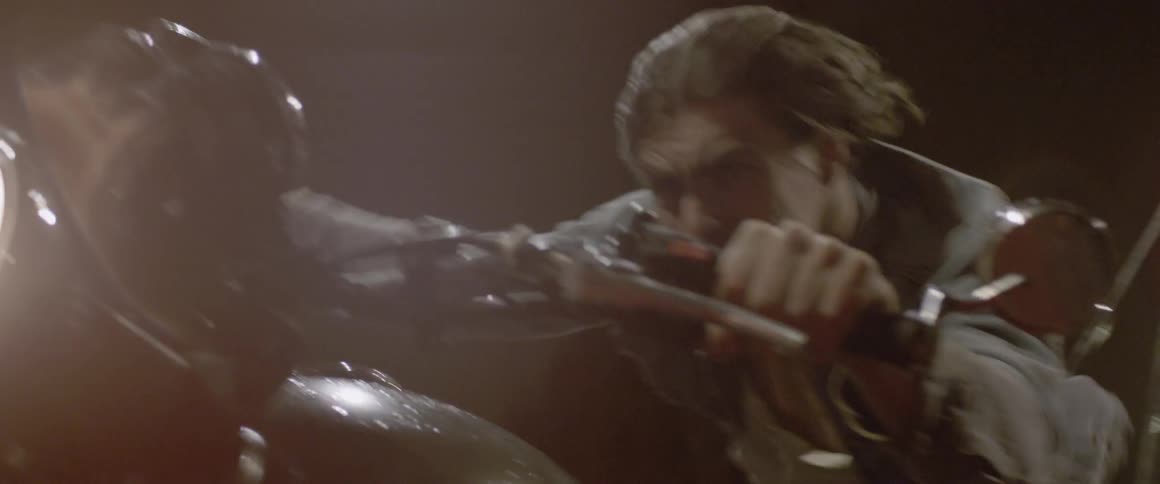 A man rides a motorcycle at a fast speed