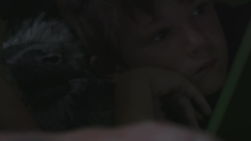 A child lays in the dark