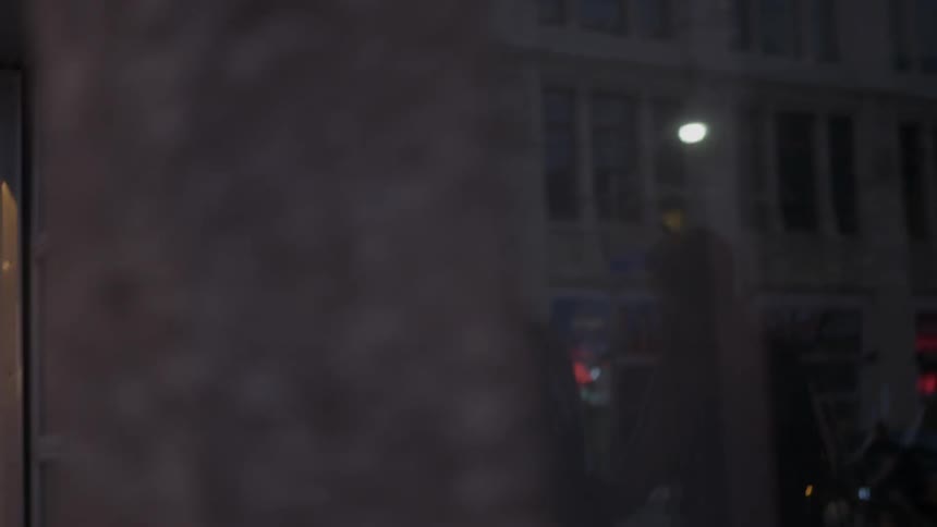 A group of female friends walking in an urban setting with graffiti covered windows and tall buildings
