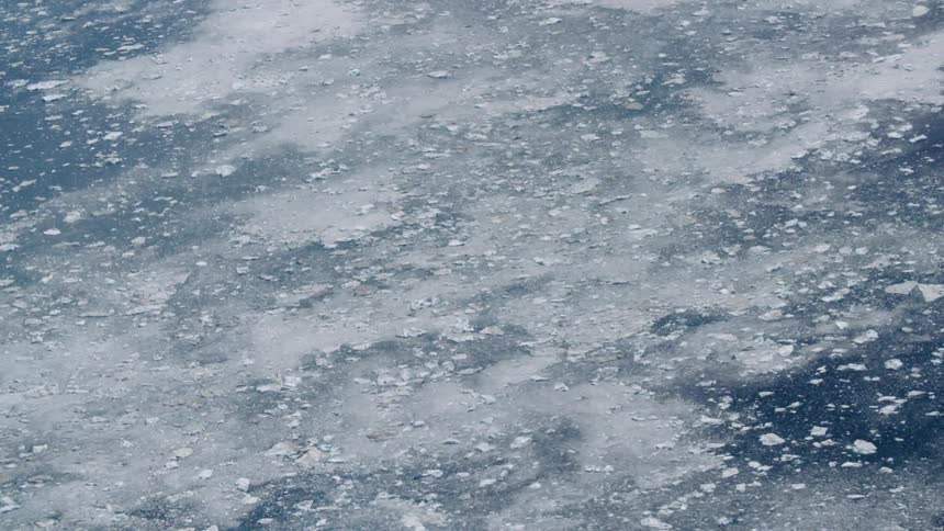 Wide aerial shot of ice flows in an ocean
