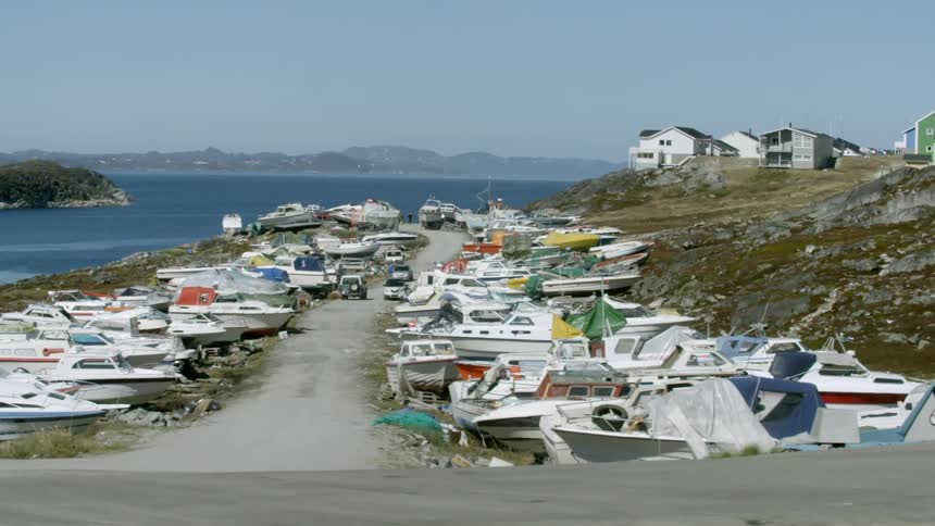 Boats on land on both sides of a road