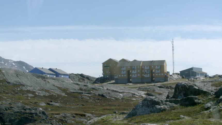 Buildings sit atop a rocky hill