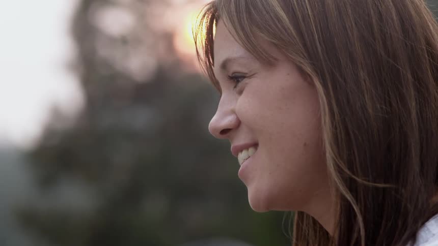 A woman smiles in slow motion